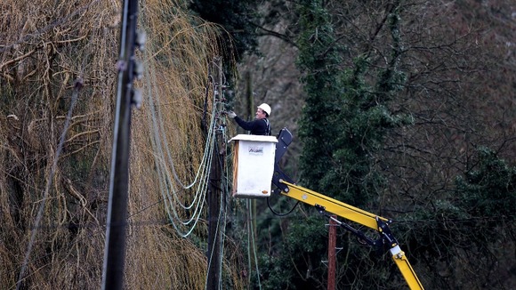 A workman works on repairing electricity lines near Reigate in Surrey