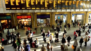 Passengers wait at Kings Cross station.