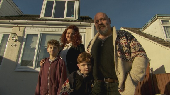 Family pose outside home