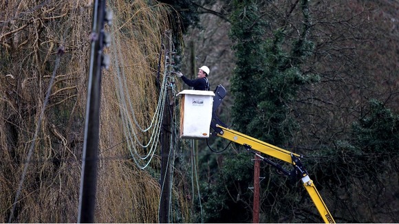 A workman repairing electricity lines near Reigate in Surrey.