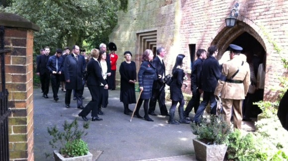 Mourners gathering at the funeral of Guardsman Michael Roland in Tollerton, Nottinghamshire