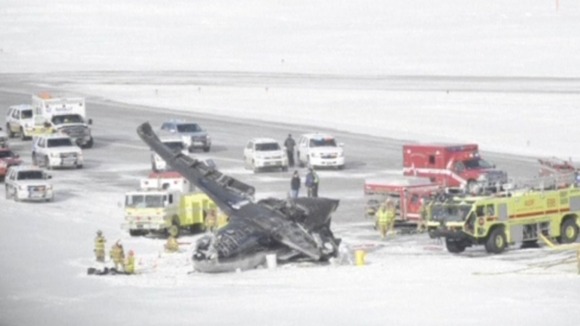 Emergency service vehicles surroud the wreckage of the plane at Aspen Airport