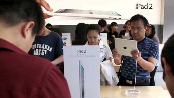 Customers look at the iPad 2 during the launch in China in 2011.