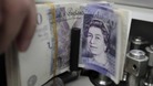 £20 notes in a machine.