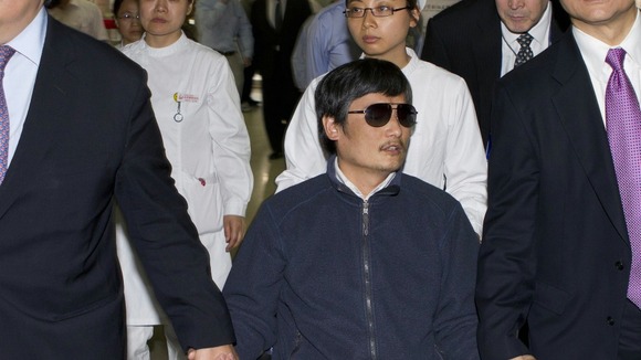 Chen Guangcheng sitting in a wheelchair as he is accompanied by US Ambassador to China Gary Locke at a hospital in Beijing on May 5.