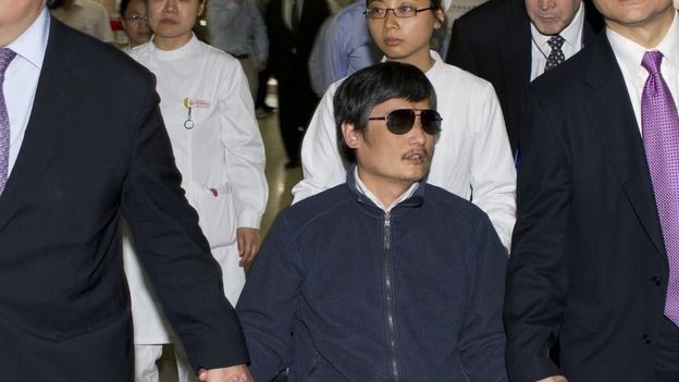 Chen Guangcheng sitting in a wheelchair as he is accompanied by US Ambassador to China Gary Locke at a hospital in Beijing on May 5.