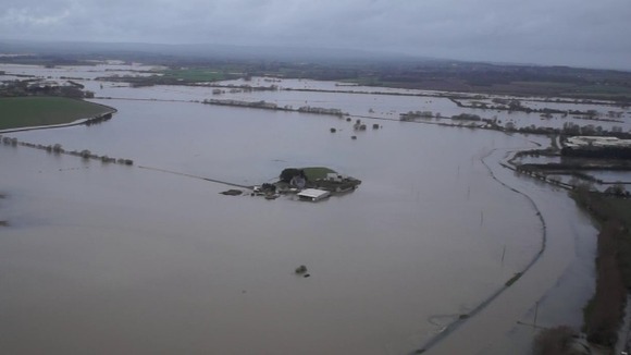 The farm, seen in the centre of the picture, has been completely surrounded by floodwater.
