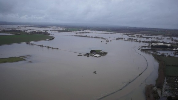 The farm, seen in the centre of the picture, has been completely surrounded by floodwater.