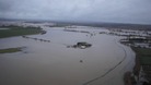 The farm, seen in the centre of the picture, has been completely surrounded by floodwater.