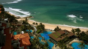 Villas by a white sand beach facing the Indian ocean at a luxurious resort in Nusa Dua, Bali