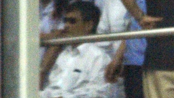 Chinese activist Chen Guangcheng, in a wheelchair, is helped to his flight at Beijing Airport as he heads to the US