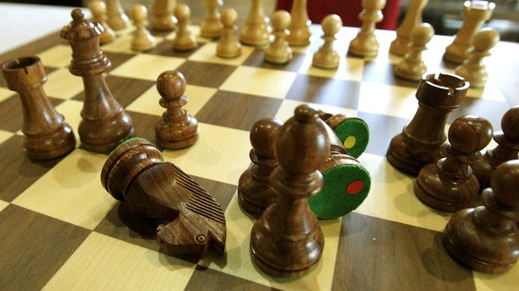 A man was knifed to death in a frenzied attack over a late night chess game, detectives believe.