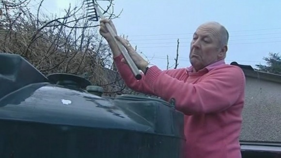 Chris Langham check the level on his heating oil.