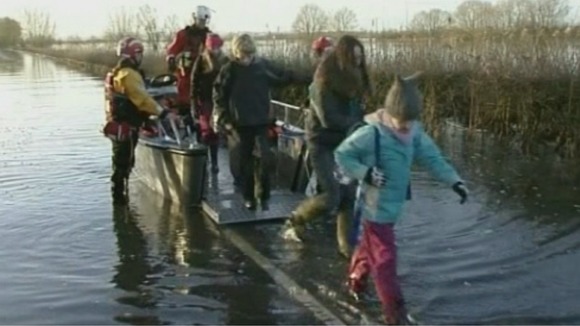 Children get a ride in a boat to get them to school.