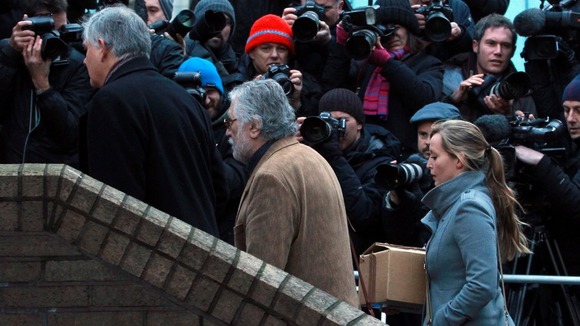 The press jostle for a shot of Dave Lee Travis arriving at court