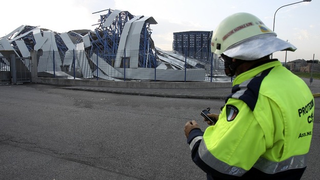 Rescue worker arrives at ceramics factory building which damaged after an earthquake in Sant' Agostino