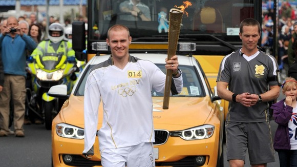 Torchbearer 014 Mark Ormrod carrying the Olympic flame on the leg between Plymouth and Modbury