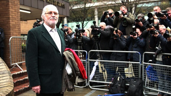 Photographers take Dave Lee Travis' photo outside the court
