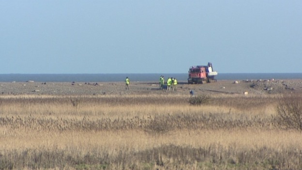 Crash investigation teams examine the wreckage