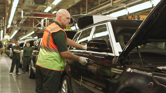 man on car production line