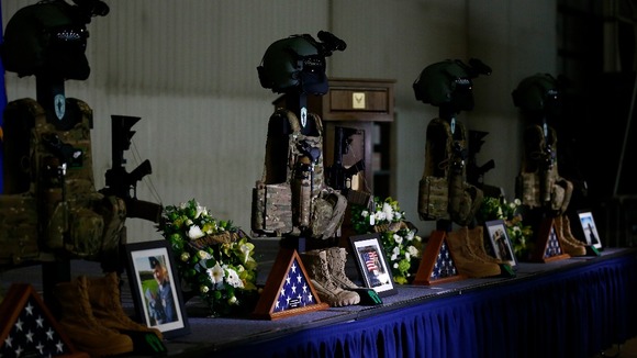 Weapons and equipment belonging to the US aircrew who died are displayed in a hangar before a memorial service