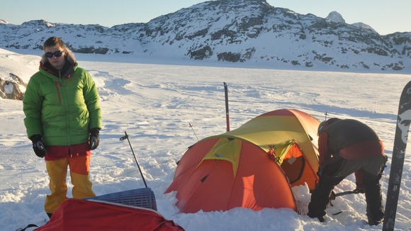 Lewis stands near one of the tents he has been sleeping in