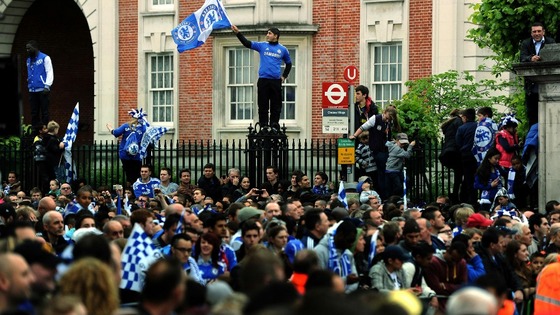 Chelsea fans gather outside Stamford Bridge before the FA Cup and UEFA Champions League trophy parade in London.