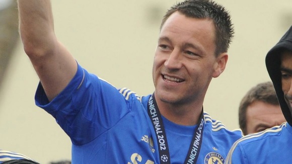Chelsea captain John Terry waves during the FA Cup and UEFA Champions League trophy parade in London
