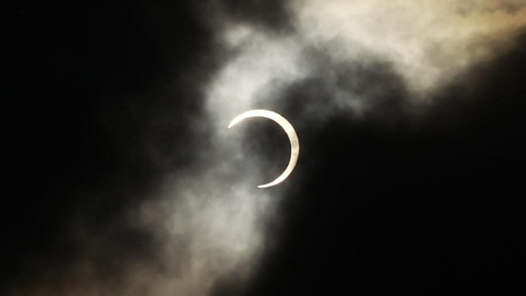 An annular solar eclipse is seen briefly during a break in clouds over Taipei, Taiwan