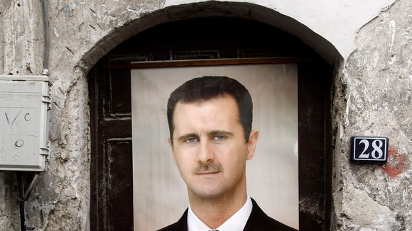 A portrait of Syrian President Bashar al-Assad hangs over a doorway in Damascus