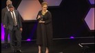 Adele collects one of her awards.