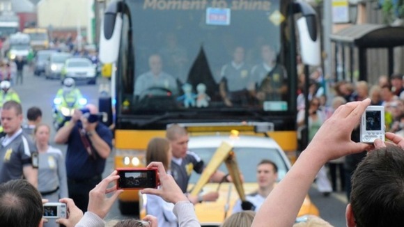 Crowds take pictures of David Follett having his flame relit