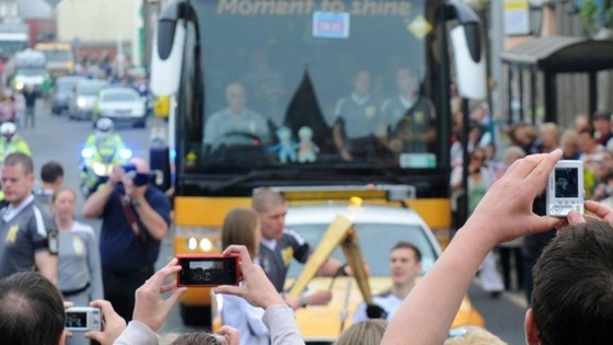 Crowds take pictures of David Follett having his flame relit 