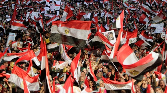 Supporters of Egypt's army chief General Abdel Fattah al-Sisi hold his posters in Tahrir square in Cairo