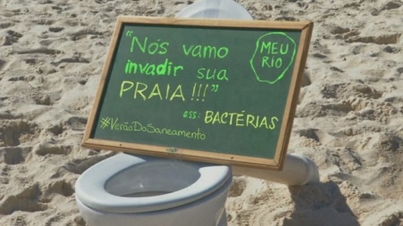 A protester's sign reads: 'Bacteria are going to invade you beach'