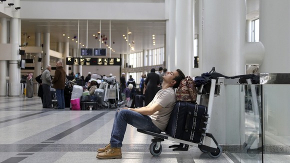 A man sleeps on his baggage