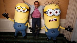 Actor Steve Carell poses with two life-size minion characters