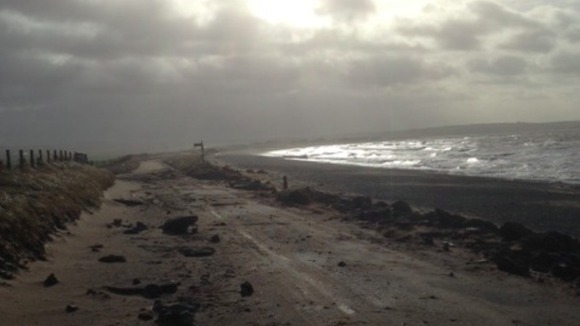 A tidal surge left debris strewn across the road.