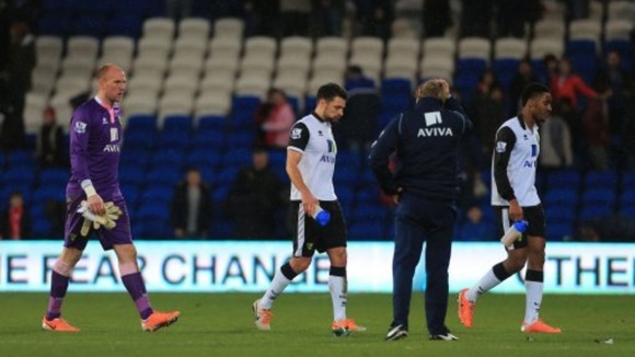 Norwich City players leave the field dejected after suffering defeat against Cardiff City.