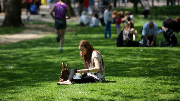 Sunbathers in St James' Park in Central London enjoying the warm May weather