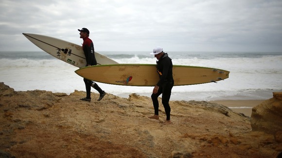 Big-wave surfers Garrett McNamara (R) of the U.S. and Andrew Cotton of Britain