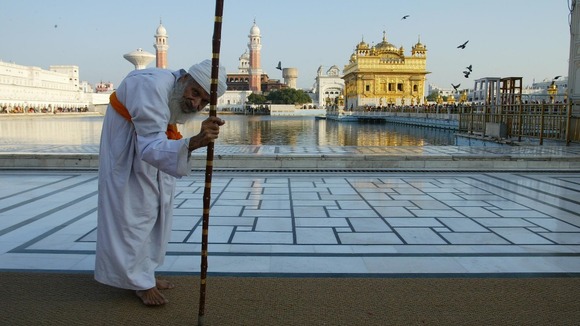 A pilgrim slowly makes his way to the Golden Temple of Amritsar.