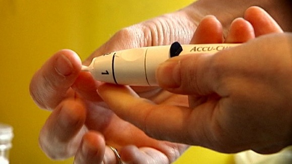 A diabetic patient takes a blood sugar level reading