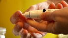 A diabetic patient takes a blood sugar level reading