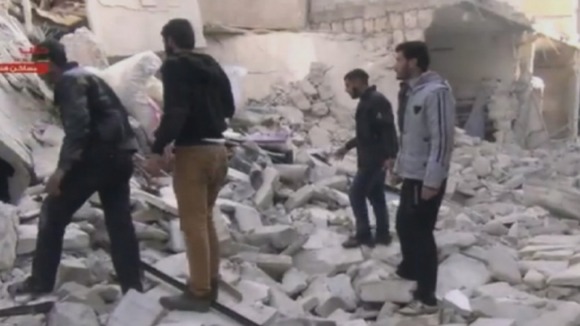 Civilians at the site of Aleppo prison after the attack