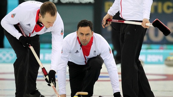 Great Britain's David Murdoch (C) with Michael Goodfellow (L) during curling training at the Ice Cube Curling Centre.