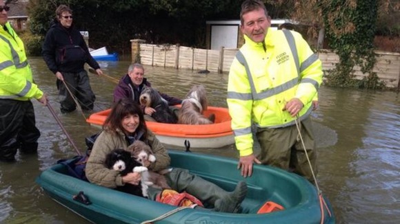 Volunteers towing residents of Wraysbury in Berkshire to safety