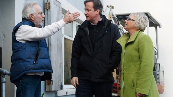 David Cameron and South East Cornwall MP Sheryll Murray (right) speak with a resident at Kingsland in the south west.