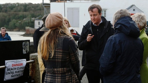 David Cameron speaks to residents whose homes were damaged during recent storms at Kingsand in south west England.