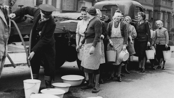 East London resident queue to get their supply of water from the Wanstead Council Water Wagon.